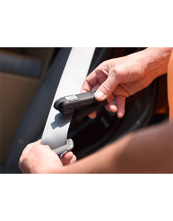 Person fastening a Free me car seat belt in a vehicle
